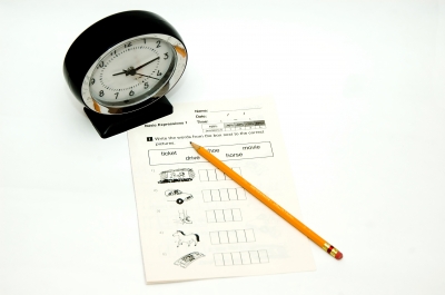 clock, pencil, test all indicate stressful, timed test at school