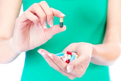 Hand holding a pill. Storing psych medication properly is very important.