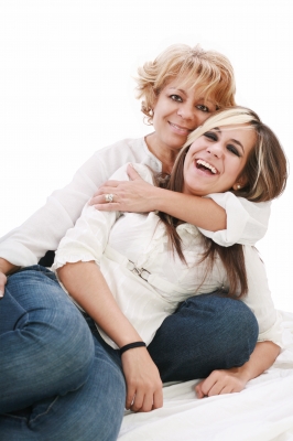 Mother wraps arms around daughter.