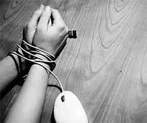 Image of hands tied by a computer mouse cord, which is what porn addiction does to its addicts.