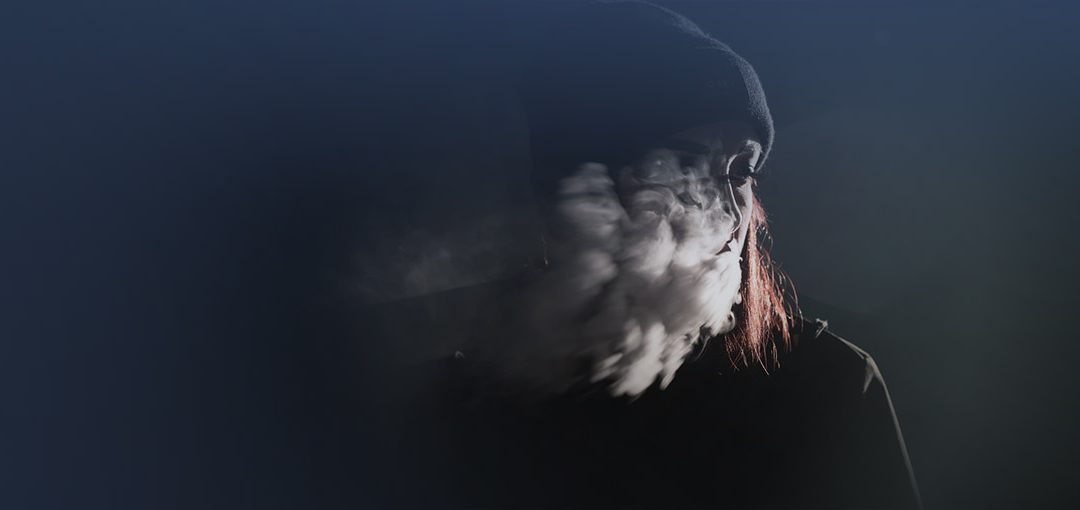 image of teen girl blowing smoke