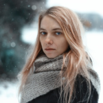 Adolescent girl standing in snow