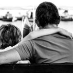 Father with arm around son teaching him instead of punishing him.