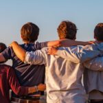 4 teenagers with arms around one another