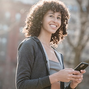 Teen girl with a cell phone in hand.