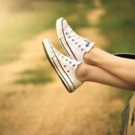 Teen with feet out car window.